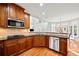 Bright kitchen with stainless appliances, hardwood floors, breakfast bar and a view into the breakfast nook at 1775 Unity Loop, Cumming, GA 30040