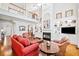 Bright living room with a fireplace, built-in shelves, and an open floorplan with a view of the second-story balcony at 1775 Unity Loop, Cumming, GA 30040