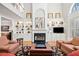 Bright living room featuring built-in shelving, a cozy fireplace, and large windows for natural light at 1775 Unity Loop, Cumming, GA 30040