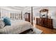 Bright main bedroom boasts hardwood floors, window shutters, and stylish furniture at 1775 Unity Loop, Cumming, GA 30040