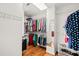 Organized walk-in closet features hanging rods and shelving for ample storage at 1775 Unity Loop, Cumming, GA 30040