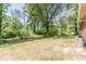 Large, grassy backyard with mature trees and landscaping provides ample space for recreation and outdoor enjoyment at 1157 Helen St, Morrow, GA 30260