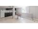 Bright kitchenette with black cabinets, white appliances, and granite countertops at 1157 Helen St, Morrow, GA 30260