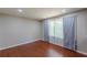 Cozy bedroom with hardwood floors, soft grey walls, and a window with sheer curtains at 1157 Helen St, Morrow, GA 30260