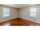 This bedroom has two windows, hardwood floors, and is freshly painted at 1157 Helen St, Morrow, GA 30260