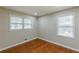 This bedroom is freshly painted with two windows and hardwood flooring at 1157 Helen St, Morrow, GA 30260