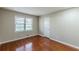 Cozy bedroom featuring hardwood floors, neutral paint, and a window at 1157 Helen St, Morrow, GA 30260