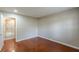 Bedroom featuring hardwood floors, neutral paint, and a door leading to a bathroom at 1157 Helen St, Morrow, GA 30260