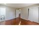 This bedroom has hardwood floors and two entry doors to bathrooms and closets at 1157 Helen St, Morrow, GA 30260
