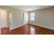 This bedroom has hardwood floors, neutral paint, and a closet with sliding doors at 1157 Helen St, Morrow, GA 30260