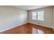 Bedroom features hardwood floors, neutral paint, and a window with blinds at 1157 Helen St, Morrow, GA 30260
