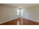 This bedroom has hardwood floors, neutral paint, and an entry to the bathroom at 1157 Helen St, Morrow, GA 30260