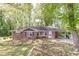 Charming brick home with a covered parking in a tree-filled neighborhood at 1157 Helen St, Morrow, GA 30260