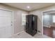 Kitchen featuring a stainless-steel refrigerator and tile floors, with an adjacent doorway at 1157 Helen St, Morrow, GA 30260