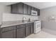 Kitchenette features granite countertops, white subway tile backsplash, and stainless steel appliances at 1157 Helen St, Morrow, GA 30260