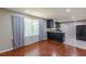 Spacious room featuring hardwood floors, large window, and an open view to the kitchen at 1157 Helen St, Morrow, GA 30260