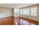 Spacious living room with hardwood floors, fresh paint, and ample natural light from a large window at 1157 Helen St, Morrow, GA 30260