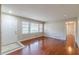 Bright living room featuring hardwood floors, neutral walls, and a large window for natural light at 1157 Helen St, Morrow, GA 30260