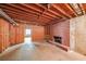 Unfinished basement area with exposed ceiling, brick wall and utility connections, offering flexible layout at 4367 S Berkeley Lake Nw Rd, Duluth, GA 30096