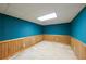 Partially finished basement with wood paneling and blue walls at 4367 S Berkeley Lake Nw Rd, Duluth, GA 30096