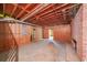 Unfinished basement area with exposed ceiling beams, brick wall and utility connections, offering a flexible layout at 4367 S Berkeley Lake Nw Rd, Duluth, GA 30096
