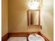 Vintage bathroom with wood paneling, sink with brass faucet, and square framed mirror at 4367 S Berkeley Lake Nw Rd, Duluth, GA 30096