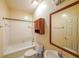 Bathroom with white tile, vanity with sink, and a tub with shower at 4367 S Berkeley Lake Nw Rd, Duluth, GA 30096