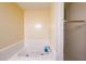Close up of bathroom showing a corner soaking tub with white tile surround and shower at 4367 S Berkeley Lake Nw Rd, Duluth, GA 30096