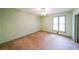 Bedroom with green walls, carpet, ceiling fan, and a window for natural light at 4367 S Berkeley Lake Nw Rd, Duluth, GA 30096