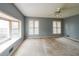 Spacious bedroom featuring a ceiling fan, three windows offering plenty of natural light, and neutral paint at 4367 S Berkeley Lake Nw Rd, Duluth, GA 30096