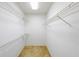 Walk-in closet with shelving units for optimal storage and organization of clothes and accessories at 4367 S Berkeley Lake Nw Rd, Duluth, GA 30096