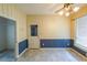 Cozy dining room with wainscoting and tile floors is bathed in natural light from a large window at 4367 S Berkeley Lake Nw Rd, Duluth, GA 30096