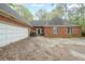 Classic brick home with attached garage and traditional curb appeal, showcasing a timeless design and structure at 4367 S Berkeley Lake Nw Rd, Duluth, GA 30096