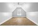 Spacious attic area with laminate flooring, ceiling fan, and natural light at 1920 Lee Patrick Dr, Dacula, GA 30019
