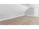 Attic space with laminate flooring, neutral paint, and door, ready for customization at 1920 Lee Patrick Dr, Dacula, GA 30019