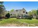 Backyard features a well-manicured lawn, mature trees, and a spacious deck at 1920 Lee Patrick Dr, Dacula, GA 30019