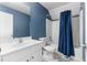Bathroom featuring a white vanity, toilet, and a shower with a blue curtain at 1920 Lee Patrick Dr, Dacula, GA 30019