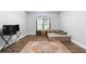 Bedroom with hardwood floors, natural light from a large window, and a neutral color palette at 1920 Lee Patrick Dr, Dacula, GA 30019