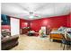 Finished basement bedroom with red accent wall, laminate flooring, and ceiling fan at 1920 Lee Patrick Dr, Dacula, GA 30019