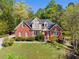 Stately two-story brick and stucco home with lush greenery, creating a picturesque and welcoming atmosphere at 1920 Lee Patrick Dr, Dacula, GA 30019