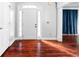 Inviting foyer with hardwood floors, white door, and sidelights, creating a bright and open entryway at 1920 Lee Patrick Dr, Dacula, GA 30019