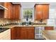 Kitchen features granite countertops, stainless steel appliances, wood cabinets, and a window at 1920 Lee Patrick Dr, Dacula, GA 30019