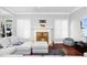 Cozy living room features a fireplace, hardwood floors, and bright windows, creating a welcoming atmosphere at 1920 Lee Patrick Dr, Dacula, GA 30019