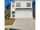 Charming two-story home with a white brick facade, a two-car garage and a well-manicured lawn at 4860 Station Lane -Lot 23, Union City, GA 30349
