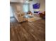 Bright living room featuring modern fireplace, stylish furniture, and sleek hardwood floors at 4860 Station Lane -Lot 23, Union City, GA 30349