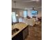 Open-concept living area connecting kitchen and seating area, features sleek hardwood floors and modern fireplace at 4860 Station Lane -Lot 23, Union City, GA 30349