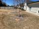 Spacious backyard featuring newly planted trees and lush greenery at 5099 Noble Village Way, Lilburn, GA 30047