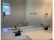 Bathroom with double sinks, quartz countertops and framed mirror at 5099 Noble Village Way, Lilburn, GA 30047