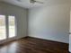 Bright bedroom features wood floor, ceiling fan, and french doors to the exterior at 5099 Noble Village Way, Lilburn, GA 30047