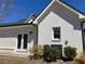 Bright white brick home featuring a well-maintained lawn and modern air conditioning unit at 5099 Noble Village Way, Lilburn, GA 30047
